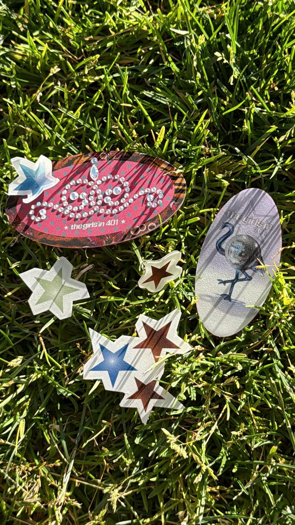 Handmade star and bird pieces in the grass